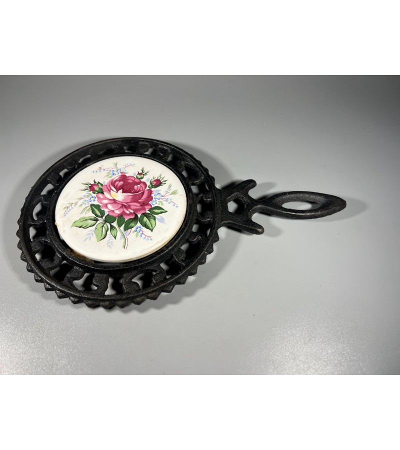 Padėklas ketaus, špižinis karštam indui padėti, su keramikos plytele, dekoruota rožių motyvu. Kaina 18