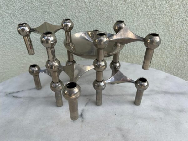 Žvakidės Nagel. Dizainas: Caesar Stoffi. Gamintojas: BMF Nagel, Vokietija. 9 vnt. standartinių po 32 eurus ir 1 vnt. dubenėlio formos, 13 cm. skersmens  43 eurai.